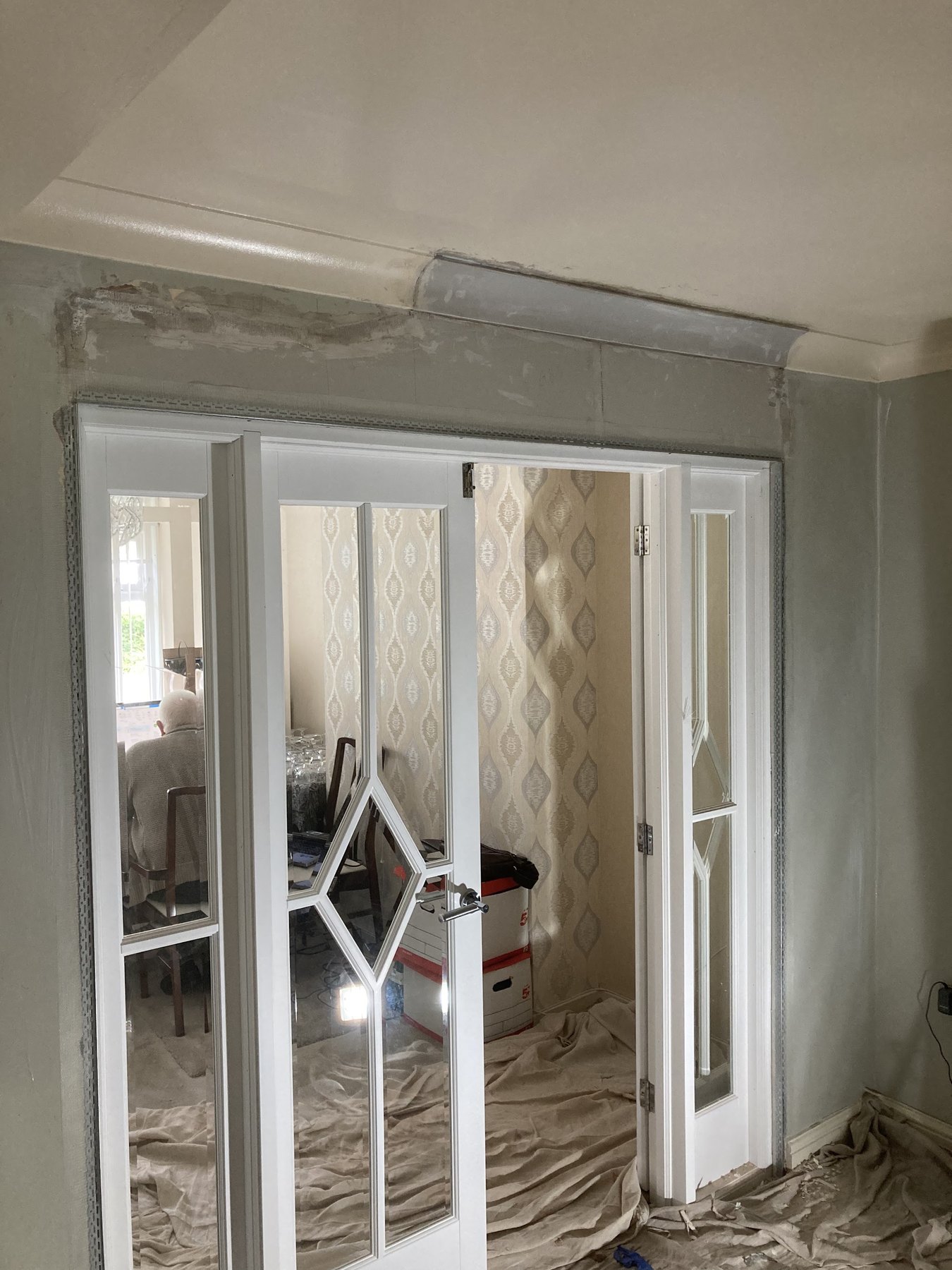 The same doorway with the wall above patched, beaded and ready to skim